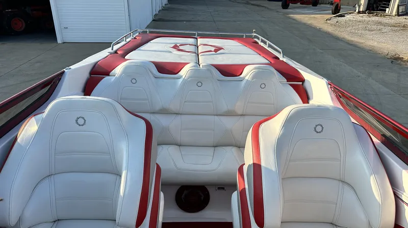 Slide: The Image of 2007 Fountain 47 Lightning boat interior with white and red seating, docked near storage units. - 24