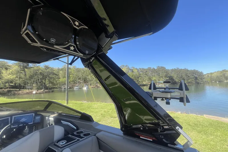 Slide: The Image of 2023 Centurion Ri265 boat with speakers by the lake. - 20