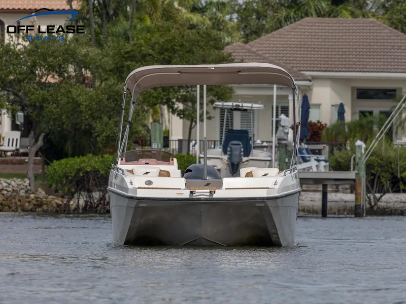 Slide: The Image of 2021 Starcraft SVX 231 OB boat on water near dock and houses. - 3