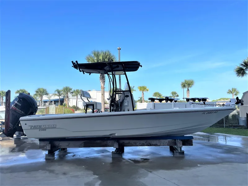 Slide: The Image of 2017 Pathfinder 2300 HPS boat on a stand with a clear blue sky background. - 1