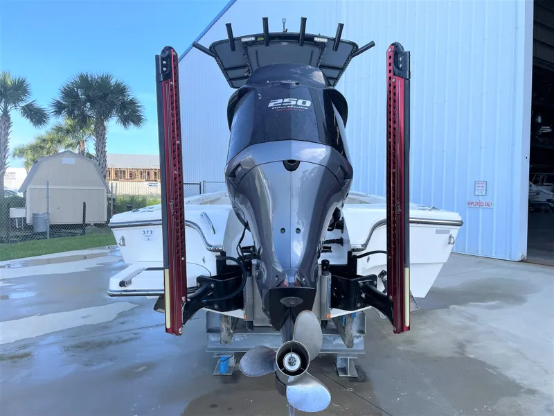 Slide: The Image of 2017 Pathfinder 2300 HPS boat with 250 horsepower engine, docked near a storage facility. - 11