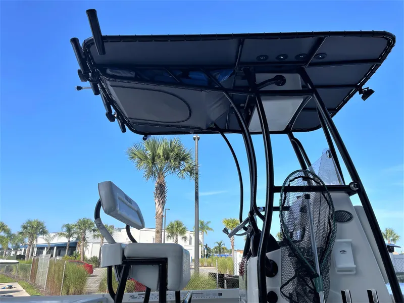 Slide: The Image of 2017 Pathfinder 2300 HPS boat with T-top and seating, docked under clear blue sky. - 23