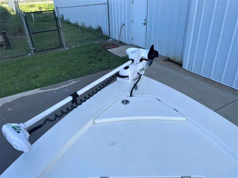 Slide: The Image of 2017 Pathfinder 2300 HPS boat with trolling motor docked near a metal fence. - 27