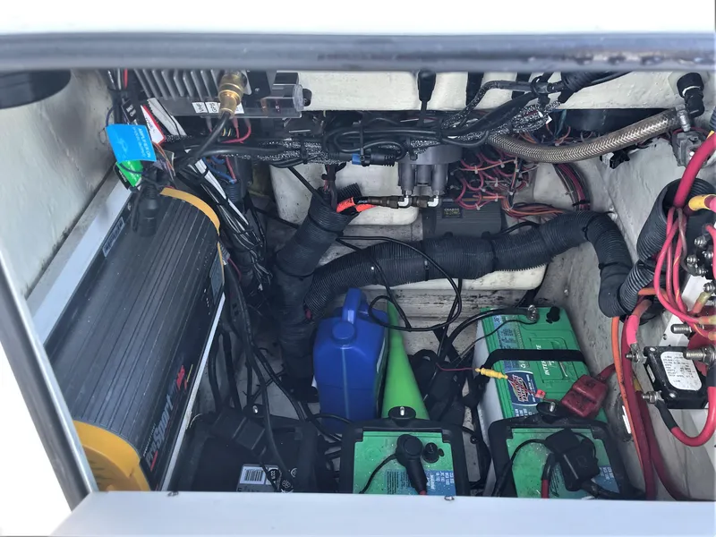 Slide: The Image of 2017 Pathfinder 2300 HPS boat battery compartment with wiring and equipment. - 34