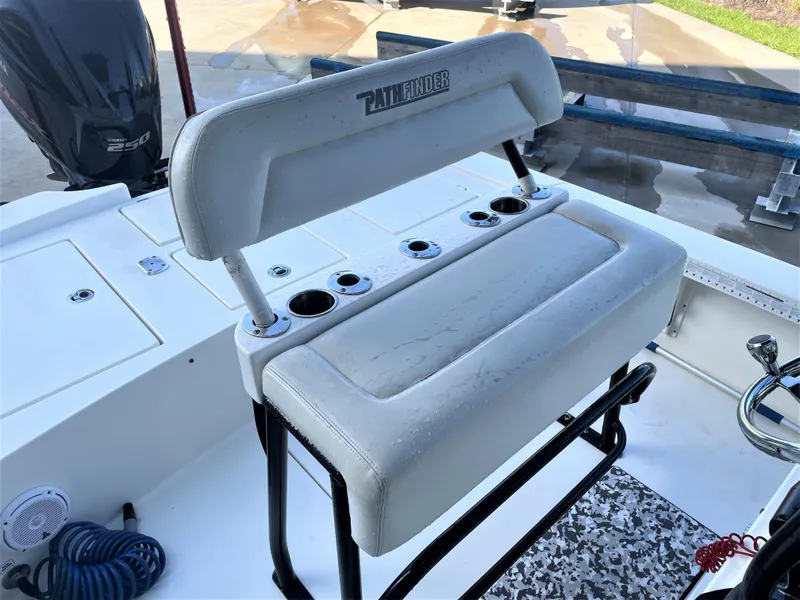 Slide: The Image of 2017 Pathfinder 2300 HPS boat with white cushioned seating and rod holders. - 35