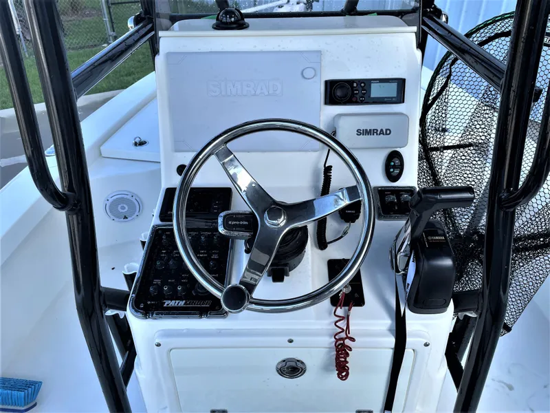Slide: The Image of 2017 Pathfinder 2300 HPS boat console with Simrad electronics and steering wheel. - 36