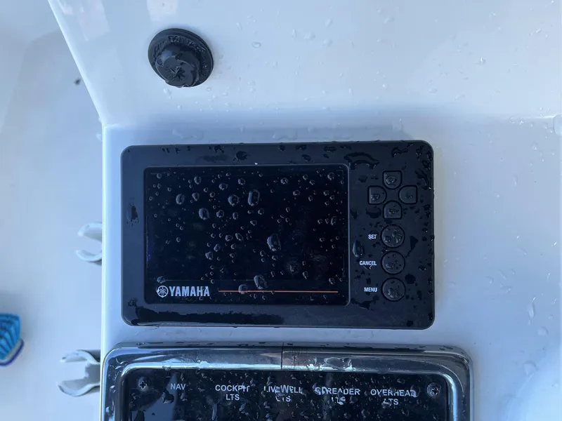 Slide: The Image of Yamaha control panel on a 2017 Pathfinder 2300 HPS boat, wet with water droplets. - 39