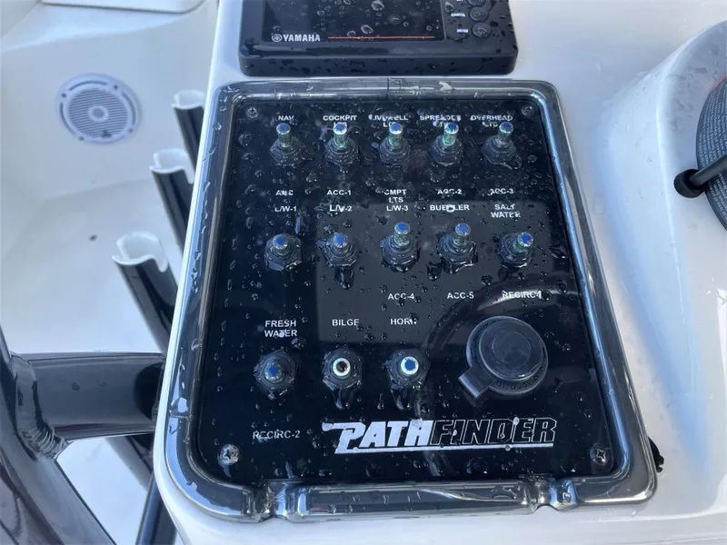 Slide: The Image of Control panel of a 2017 Pathfinder 2300 HPS boat with various switches. - 40