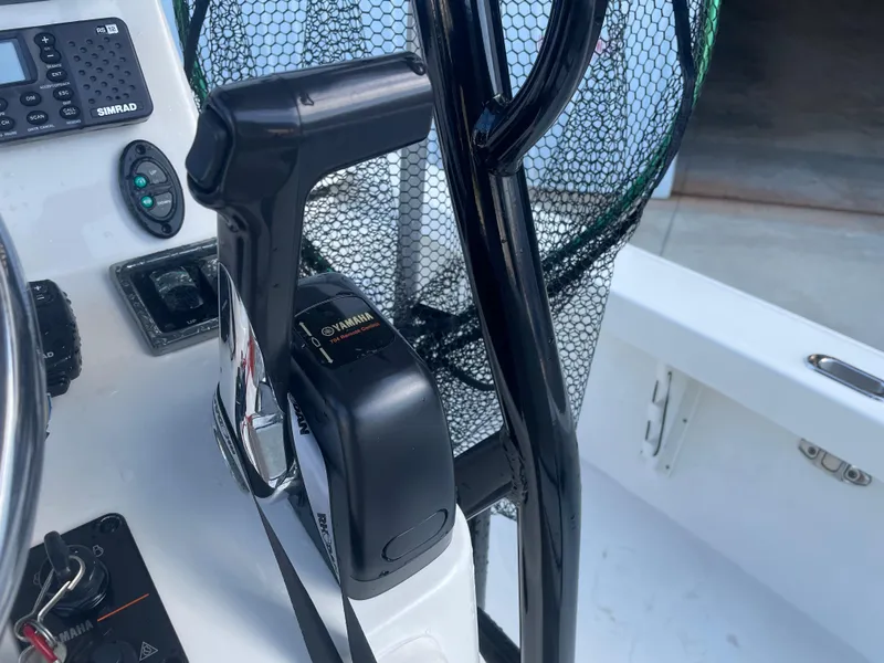 Slide: The Image of Close-up of the control panel and throttle of a 2017 Pathfinder 2300 HPS boat. - 41