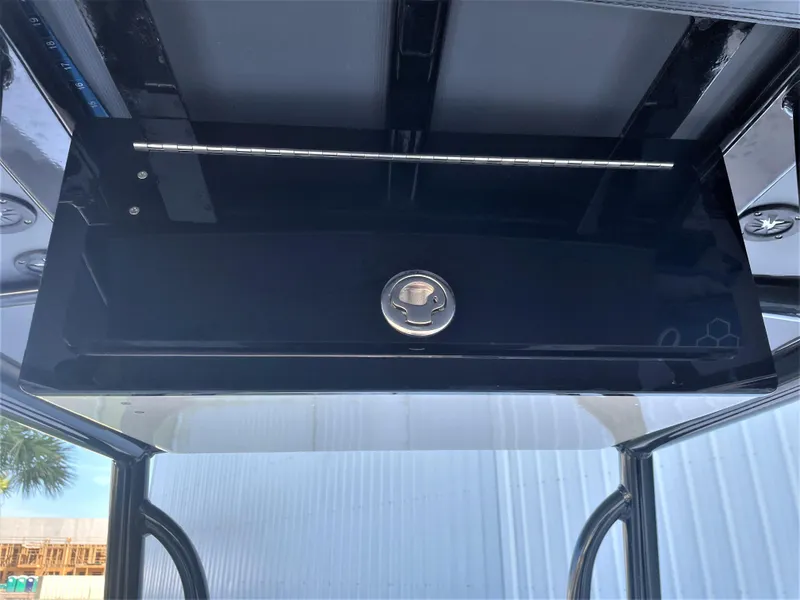 Slide: The Image of 2017 Pathfinder 2300 HPS boat console with black storage compartment. - 44