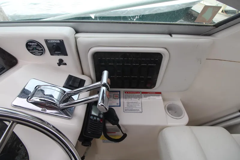 Slide: The Image of Control panel of a 1998 Wellcraft 3200 Martinique boat with steering wheel and throttle. - 10