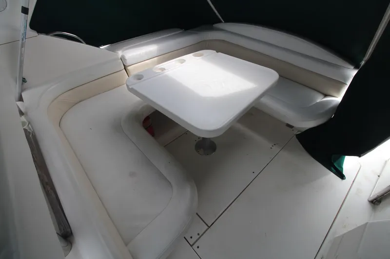 Slide: The Image of 1998 Wellcraft 3200 Martinique boat interior with white seating and table. - 11