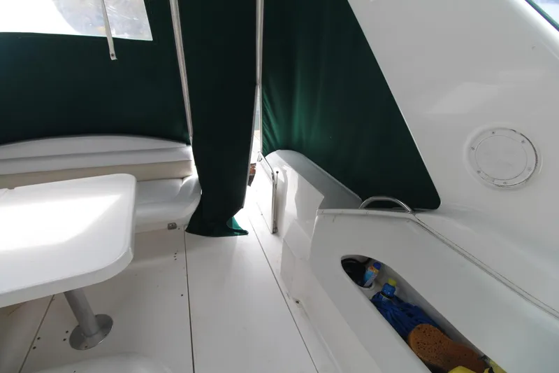 Slide: The Image of 1998 Wellcraft 3200 Martinique boat interior with seating and green canopy. - 14