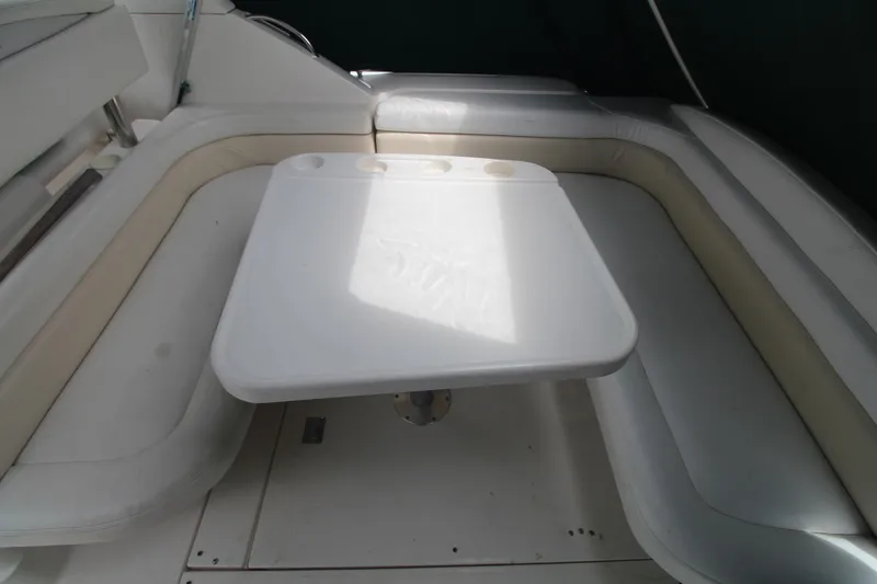 Slide: The Image of 1998 Wellcraft 3200 Martinique boat interior with white seating and table. - 15