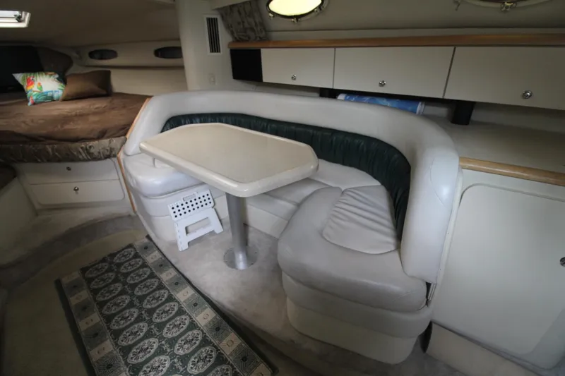 Slide: The Image of 1998 Wellcraft 3200 Martinique cabin interior with dining area and seating. - 19