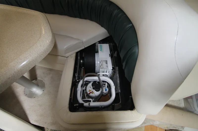 Slide: The Image of 1998 Wellcraft 3200 Martinique interior with exposed mechanical components under seating. - 25