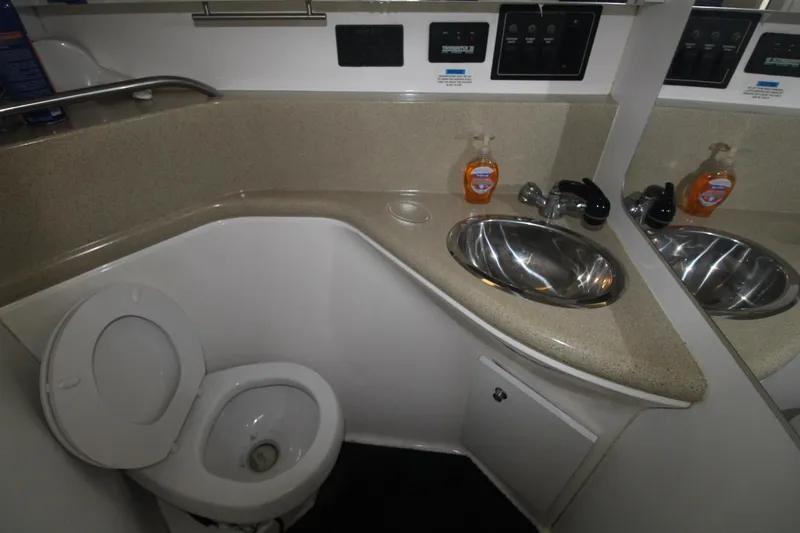 Slide: The Image of 1998 Wellcraft 3200 Martinique bathroom with toilet, sink, and countertop. - 28