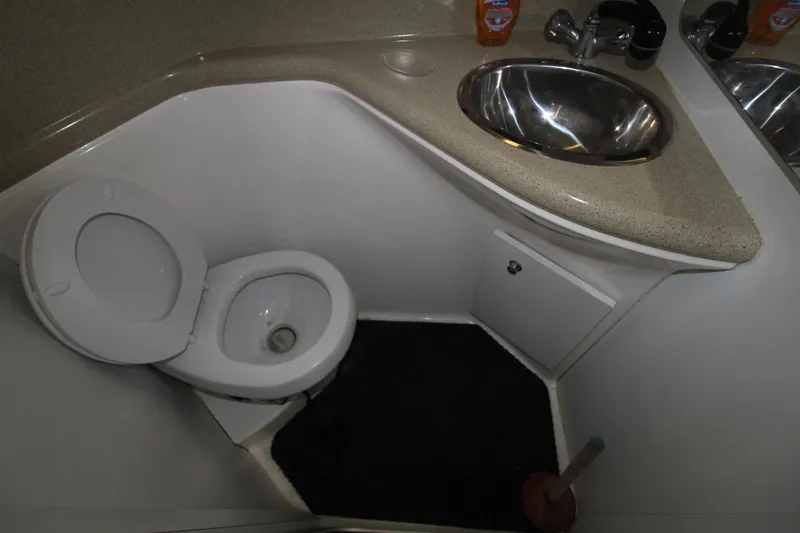 Slide: The Image of 1998 Wellcraft 3200 Martinique boat bathroom with toilet and sink. - 29