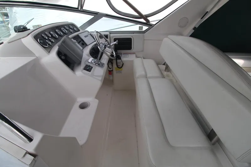 Slide: The Image of 1998 Wellcraft 3200 Martinique boat interior with steering wheel and dashboard controls. - 4