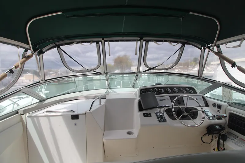 Slide: The Image of 1998 Wellcraft 3200 Martinique boat cockpit with steering wheel and dashboard controls. - 6