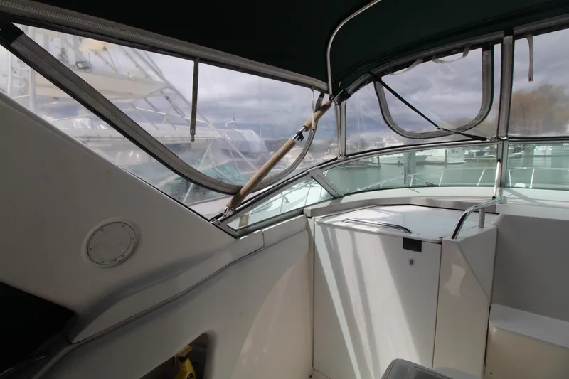 Slide: The Image of 1998 Wellcraft 3200 Martinique boat interior with covered cockpit and windows. - 7