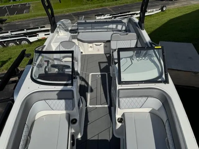 Slide: The Image of 2024 Bayliner DX 2250 boat interior with open seating and dual windshields. - 12