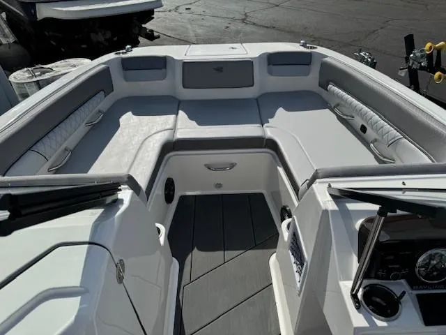 Slide: The Image of 2024 Bayliner DX 2250 boat interior with cushioned seating and control panel. - 5