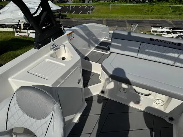 Slide: The Image of 2024 Bayliner DX 2250 boat interior with seating and sink. - 9