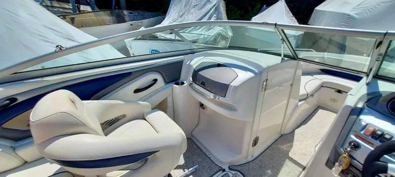 Slide: The Image of Interior of a 2006 Monterey 234 FS boat with white and blue seating. - 10