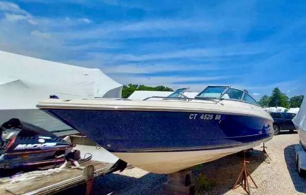 Slide: The Image of 2006 Monterey 234 FS boat on dry dock under a clear blue sky. - 12