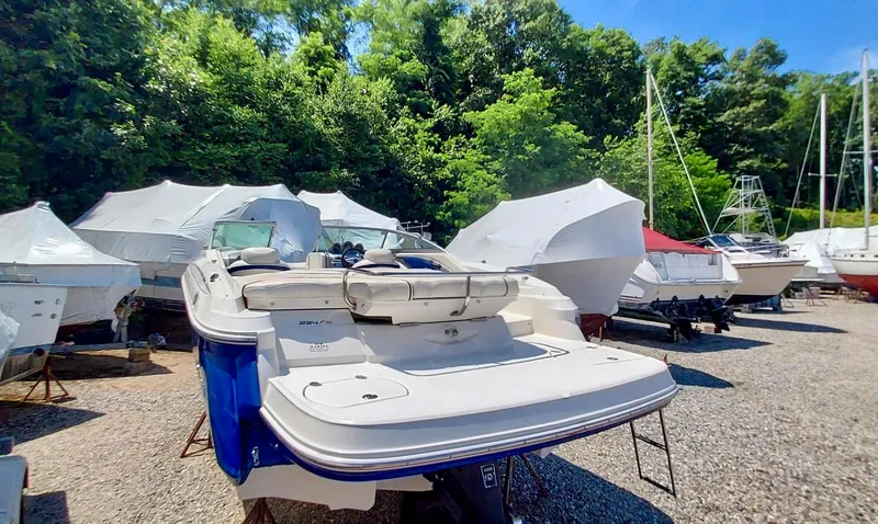 Slide: The Image of 2006 Monterey 234 FS boat in a storage yard with other covered boats. - 13