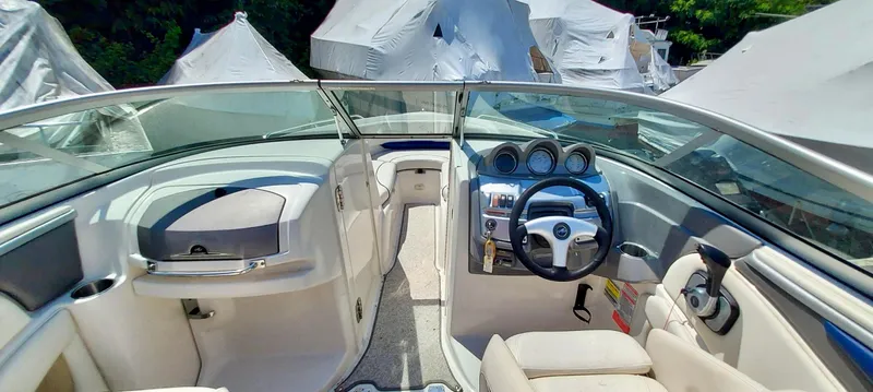 Slide: The Image of 2006 Monterey 234 FS boat interior with steering wheel and dashboard. - 6