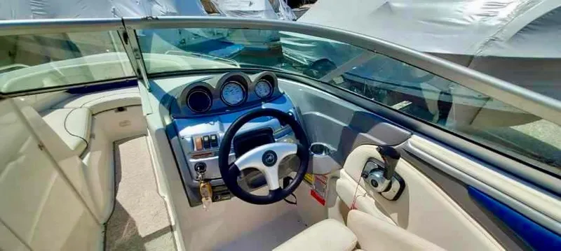 Slide: The Image of 2006 Monterey 234 FS boat cockpit with steering wheel and dashboard. - 7