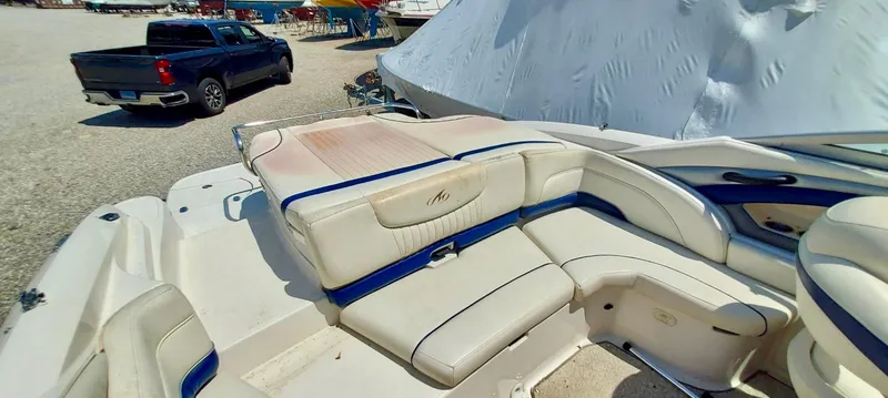 Slide: The Image of 2006 Monterey 234 FS boat interior with white and blue seating. - 8