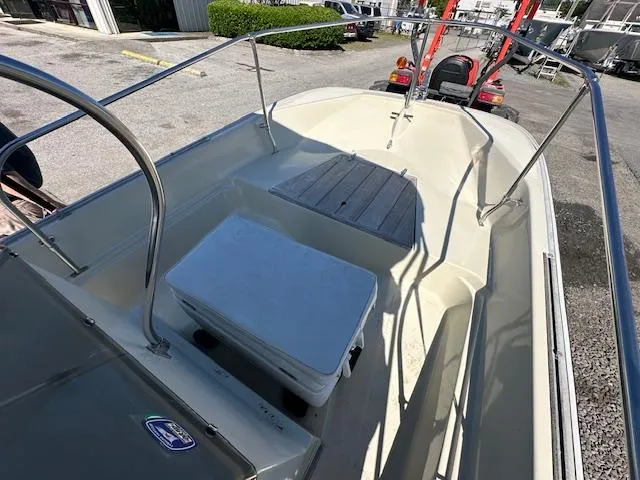 Slide: The Image of 1987 Boston Whaler 17 Montauk boat interior with cooler and seating. - 10