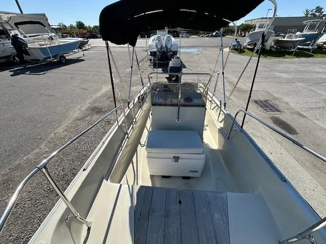 Slide: The Image of 1987 Boston Whaler 17 Montauk boat with canopy, docked at marina. - 13