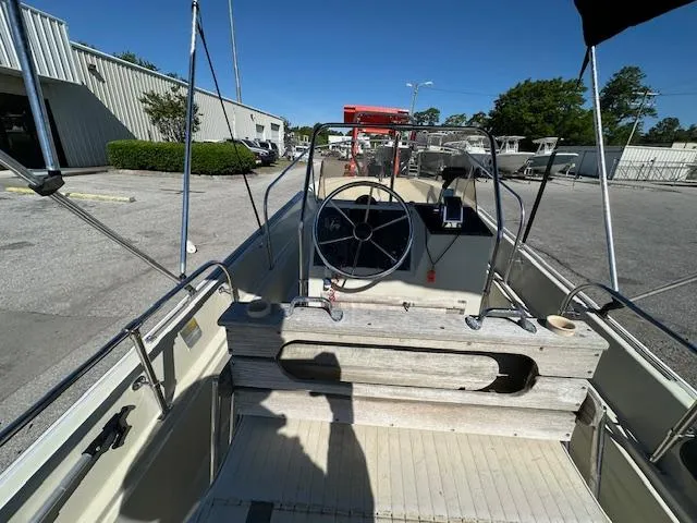 Slide: The Image of 1987 Boston Whaler 17 Montauk boat interior with steering wheel and console. - 15