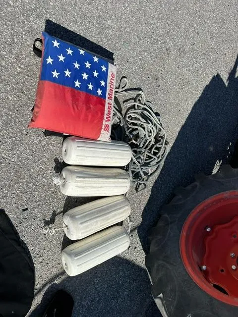 Slide: The Image of Boat accessories for 1987 Boston Whaler 17 Montauk: fenders, anchor, and American flag. - 18