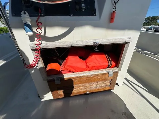 Slide: The Image of Storage compartment with life jackets on a 1987 Boston Whaler 17 Montauk boat. - 20
