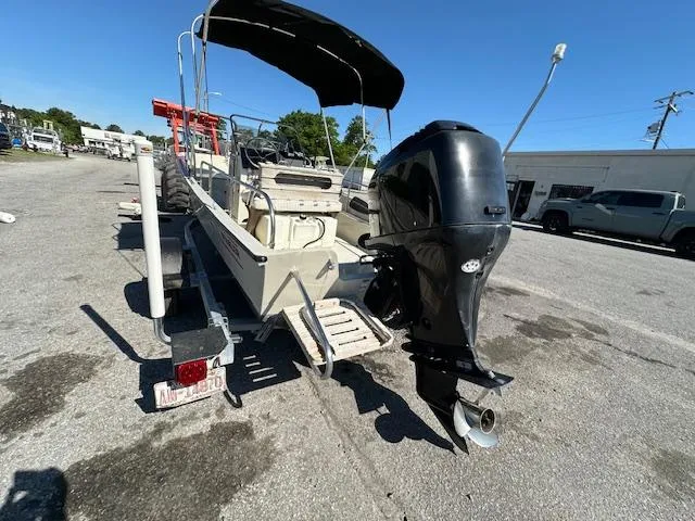 Slide: The Image of 1987 Boston Whaler 17 Montauk boat on trailer with outboard motor and canopy. - 4