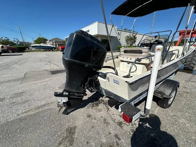 Slide: The Image of 1987 Boston Whaler 17 Montauk boat with outboard motor on trailer. - 6