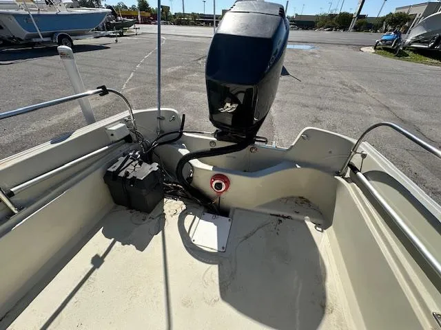 Slide: The Image of 1987 Boston Whaler 17 Montauk boat stern with outboard motor and battery. - 7