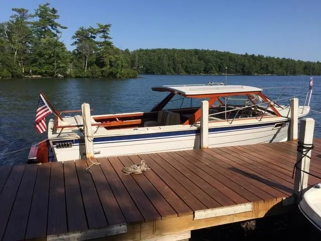 Slide: The Image of 1986 Skiff Craft Sport Fisherman 260 docked by a wooden pier on a serene lake. - 10