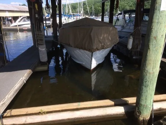 Slide: The Image of 1986 Skiff Craft Sport Fisherman 260 docked with cover in marina. - 14