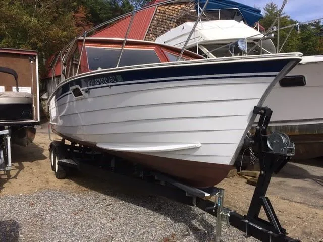 Slide: The Image of 1986 Skiff Craft Sport Fisherman 260 on a trailer, docked outdoors. - 15