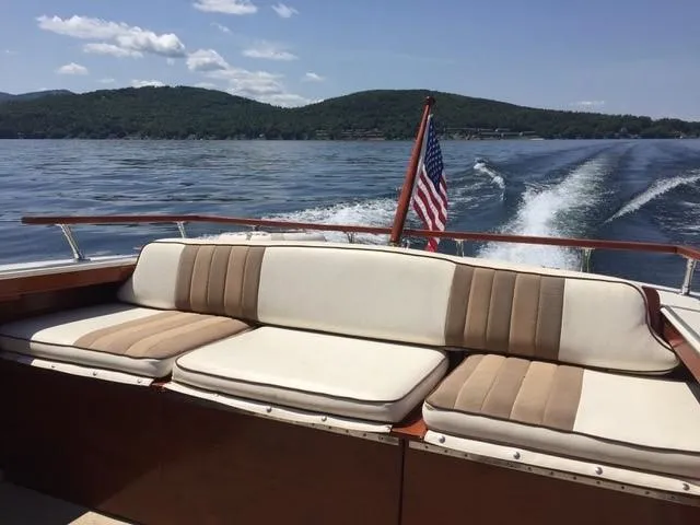 Slide: The Image of 1986 Skiff Craft Sport Fisherman 260 cruising on a lake with scenic mountain views. - 3