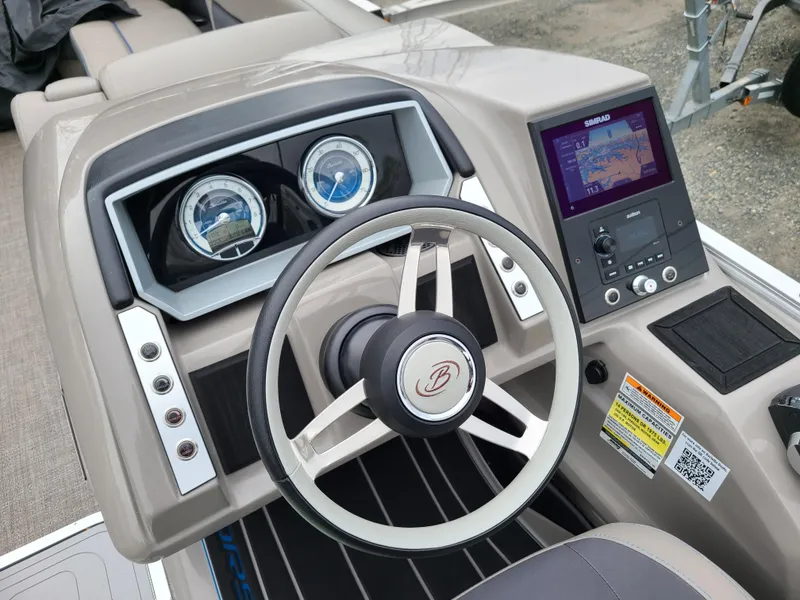 Slide: The Image of 2022 Barletta CORSA 25UC boat dashboard with steering wheel and navigation system. - 19