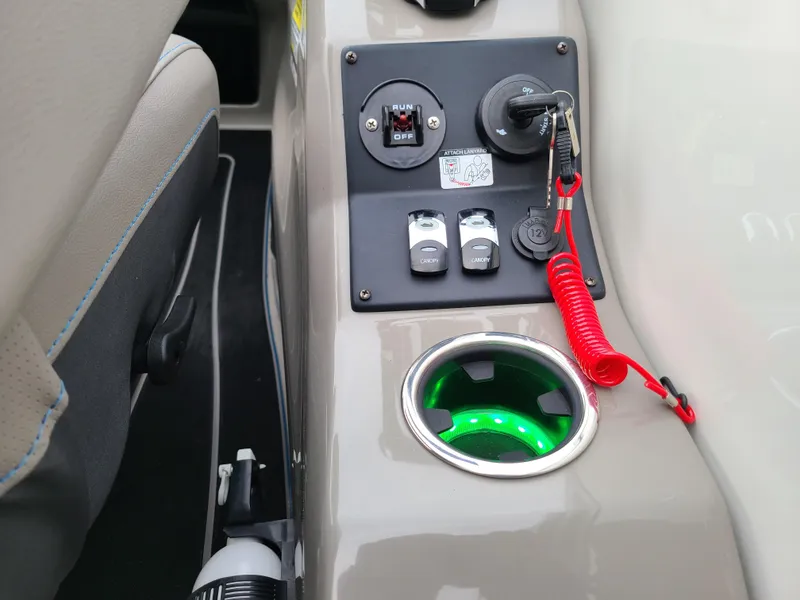 Slide: The Image of 2022 Barletta CORSA 25UC control panel with illuminated cup holder and ignition key. - 40