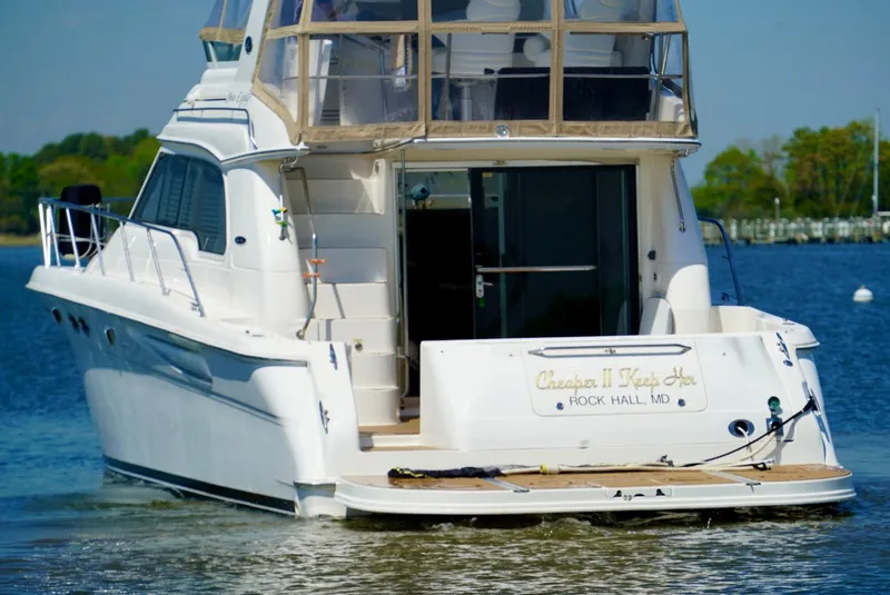 Slide: The Image of 2002 Sea Ray 480 Sedan Bridge yacht on water, rear view. - 10