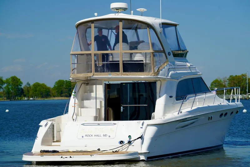 Slide: The Image of 2002 Sea Ray 480 Sedan Bridge yacht on calm water. - 12